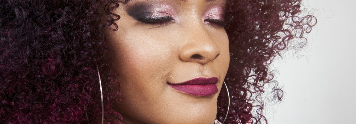 curly haired model smiling